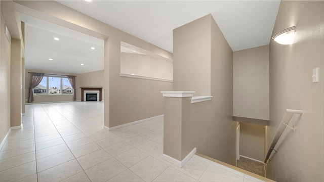 hall featuring baseboards, recessed lighting, light tile patterned flooring, and an upstairs landing