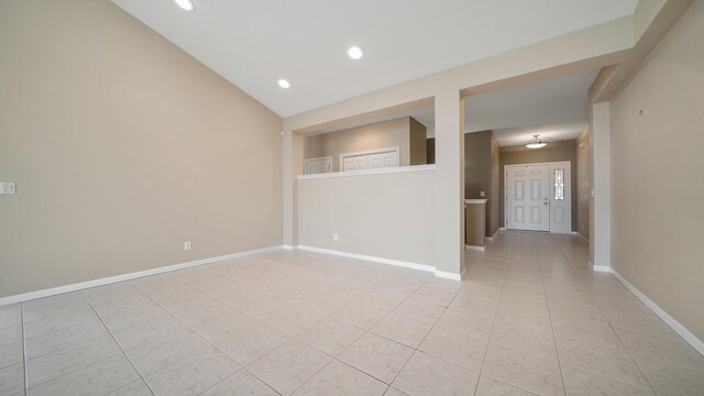 unfurnished room with light tile patterned floors, baseboards, and recessed lighting