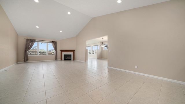 unfurnished living room featuring recessed lighting, baseboards, a glass covered fireplace, and light tile patterned floors