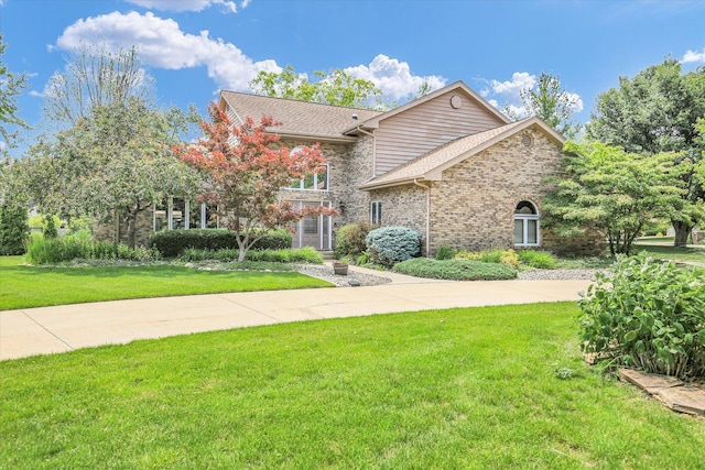 1801 Bentbrook Dr, Champaign, IL 61822 - view of front of house with a front lawn, brick siding, and roof with shingles