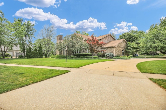 1801 Bentbrook Dr, Champaign, IL 61822 - obstructed view of property with a front lawn, curved driveway, and a chimney