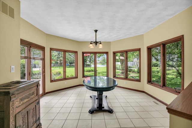 1801 Bentbrook Dr, Champaign, IL 61822 - unfurnished sunroom featuring baseboards, tile patterned floors, and a chandelier