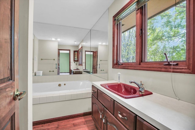 1801 Bentbrook Dr, Champaign, IL 61822 - full bath featuring vanity, wood finished floors, and a bath