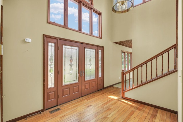 1801 Bentbrook Dr, Champaign, IL 61822 - foyer with a towering ceiling, stairs, light wood finished floors, french doors, and baseboards