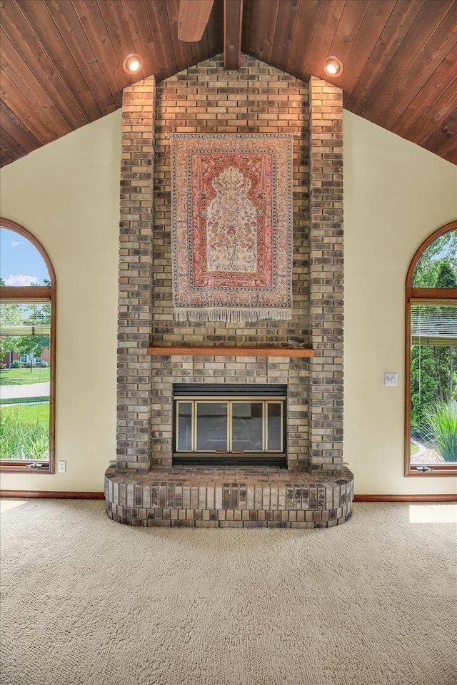 1801 Bentbrook Dr, Champaign, IL 61822 - unfurnished living room featuring vaulted ceiling, carpet flooring, a fireplace, baseboards, and wooden ceiling