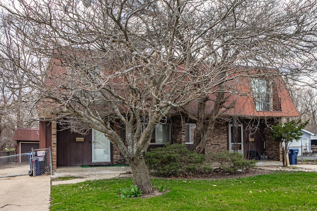 view of front of home featuring a gate, fence, a front yard, and a garage