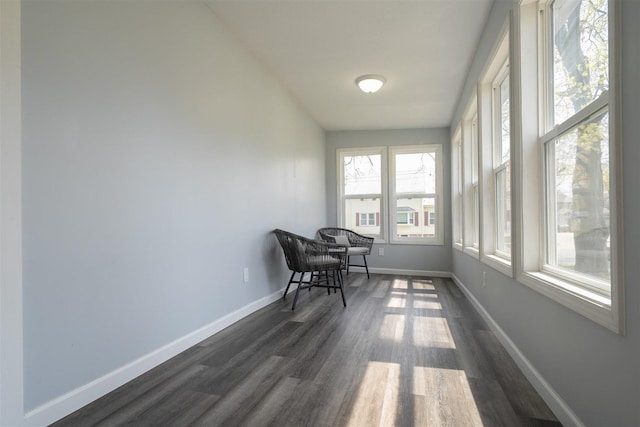 sunroom / solarium with baseboards and wood finished floors