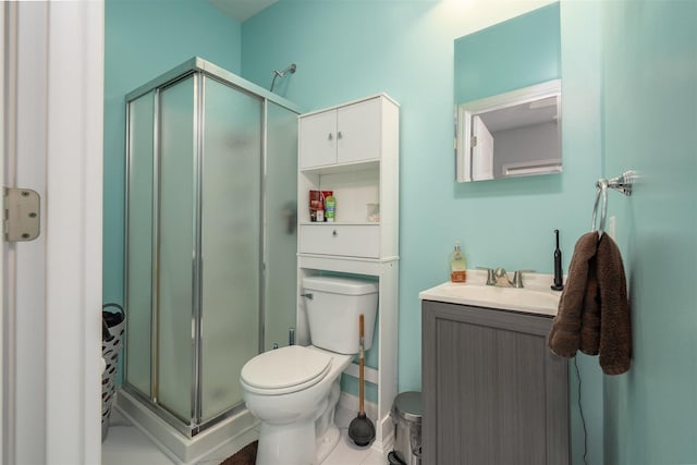 bathroom with tile patterned flooring, toilet, vanity, and a stall shower