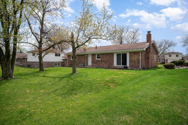 6226 Beechwood Rd, Matteson, IL 60443 - back of property with a yard, a chimney, and brick siding