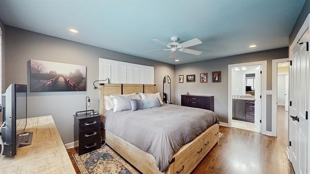 bedroom featuring recessed lighting, a ceiling fan, baseboards, wood finished floors, and ensuite bathroom