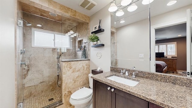 bathroom featuring vanity, toilet, a stall shower, visible vents, and ensuite bathroom