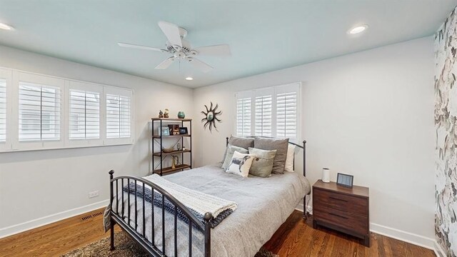 bedroom featuring baseboards, recessed lighting, and wood finished floors