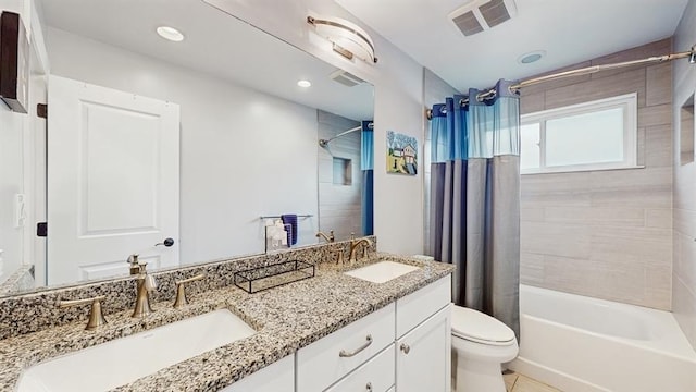 bathroom featuring shower / tub combo with curtain, visible vents, toilet, and a sink