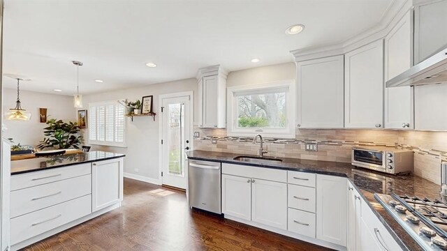 kitchen featuring white cabinetry, a healthy amount of sunlight, appliances with stainless steel finishes, and a sink