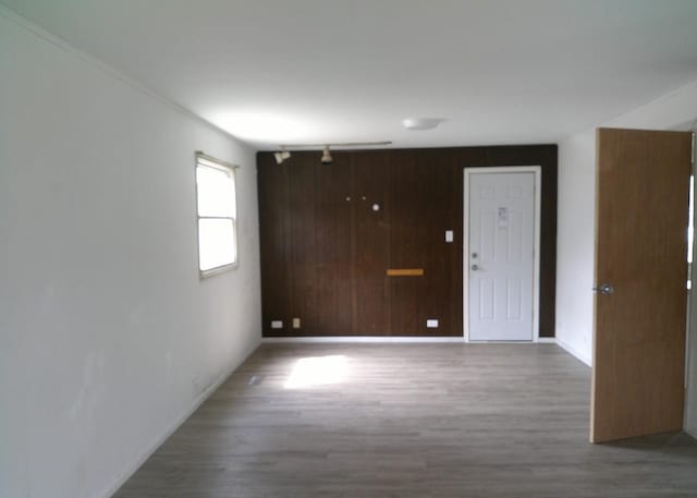 1507 Thornton Dr, Champaign, IL 61821 - unfurnished room featuring wood walls, baseboards, and wood finished floors