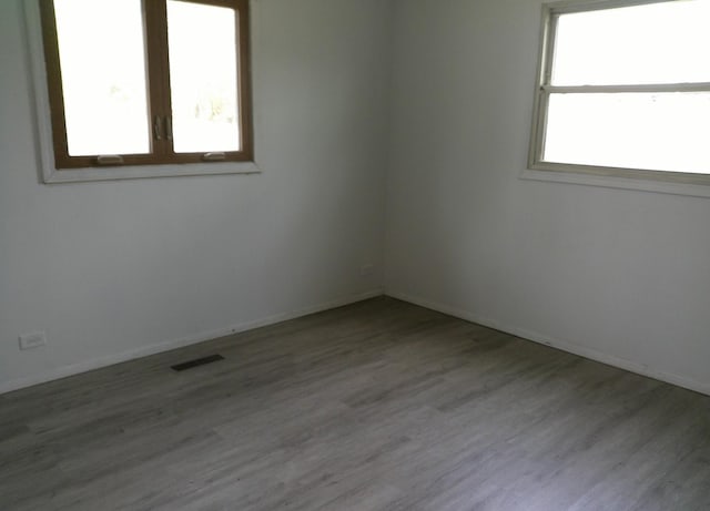 1507 Thornton Dr, Champaign, IL 61821 - unfurnished room featuring wood finished floors, baseboards, and visible vents