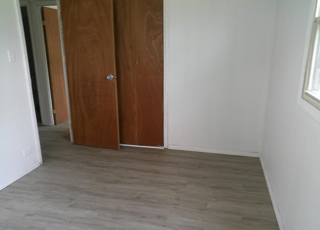 1507 Thornton Dr, Champaign, IL 61821 - unfurnished bedroom featuring baseboards and wood finished floors