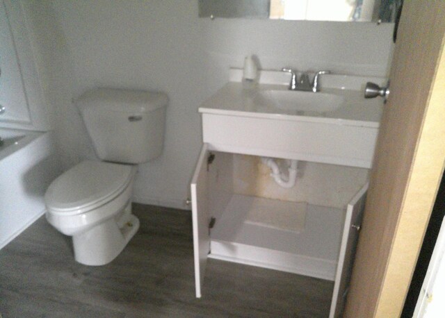 1507 Thornton Dr, Champaign, IL 61821 - bathroom featuring toilet, wood finished floors, and vanity