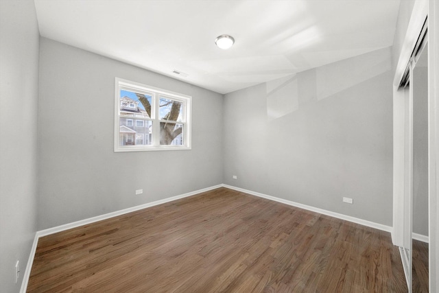 2200 N Kildare Ave, Chicago, IL 60639 - unfurnished bedroom with visible vents, baseboards, and wood finished floors