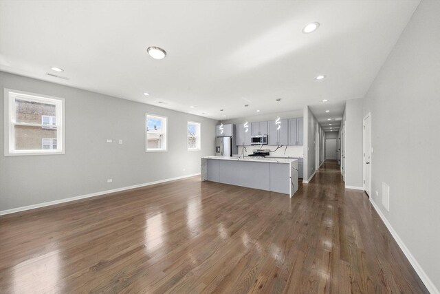 2200 N Kildare Ave, Chicago, IL 60639 - unfurnished living room featuring recessed lighting, baseboards, and dark wood finished floors