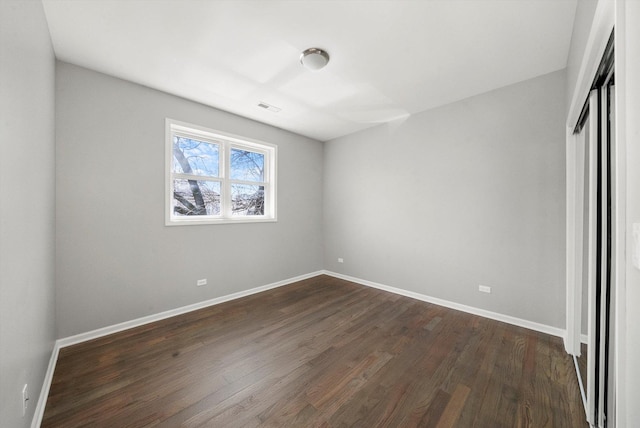 2200 N Kildare Ave, Chicago, IL 60639 - unfurnished bedroom featuring a closet, dark wood-style flooring, baseboards, and visible vents