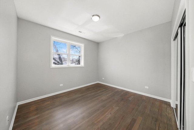 2200 N Kildare Ave, Chicago, IL 60639 - unfurnished bedroom featuring a closet, dark wood-type flooring, visible vents, and baseboards