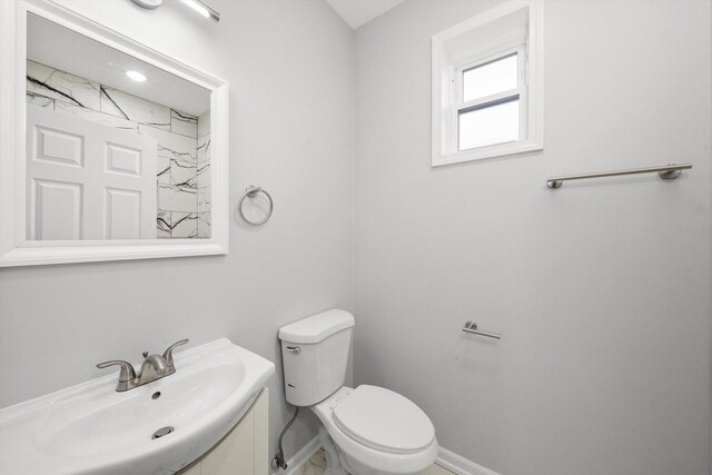 2200 N Kildare Ave, Chicago, IL 60639 - bathroom featuring toilet, vanity, and baseboards