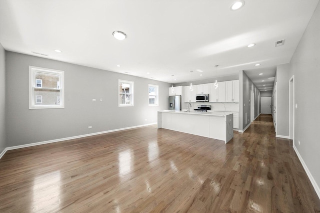 2200 N Kildare Ave, Chicago, IL 60639 - unfurnished living room with a sink, visible vents, recessed lighting, and dark wood-type flooring