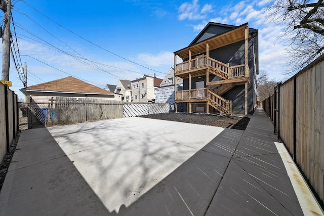 2200 N Kildare Ave, Chicago, IL 60639 - back of property featuring stairs, a fenced backyard, and a patio area