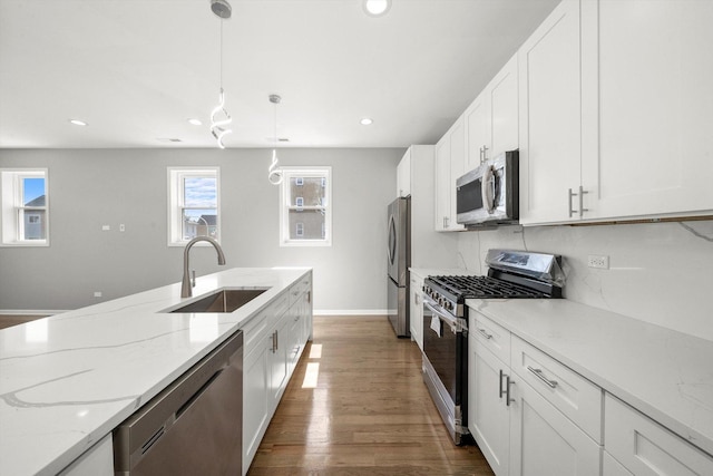 2200 N Kildare Ave, Chicago, IL 60639 - kitchen featuring white cabinets, recessed lighting, a sink, stainless steel appliances, and baseboards