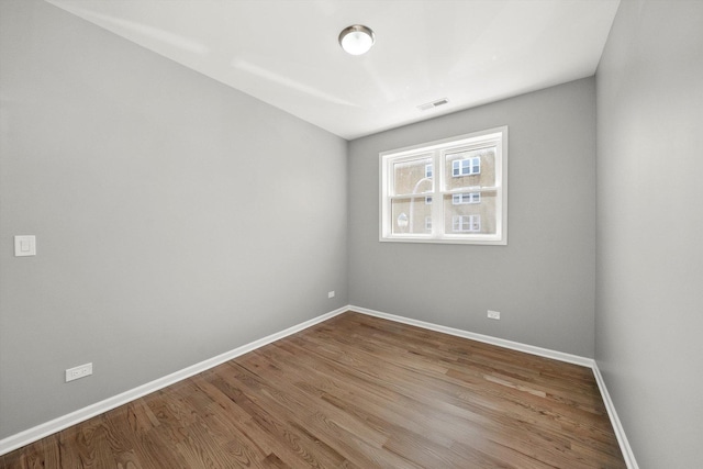 2200 N Kildare Ave, Chicago, IL 60639 - spare room featuring wood finished floors, baseboards, and visible vents