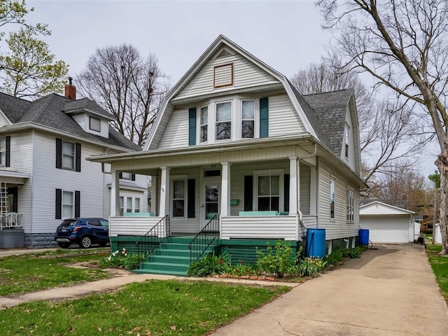 1910 E Taylor St, Bloomington, IL 61701 - colonial inspired home featuring covered porch, an outdoor structure, a gambrel roof, a garage, and a shingled roof