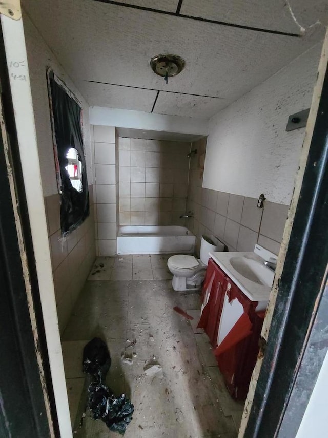 10452 S State St, Chicago, IL 60628 - full bathroom with toilet, tiled shower / bath combo, tile walls, and vanity