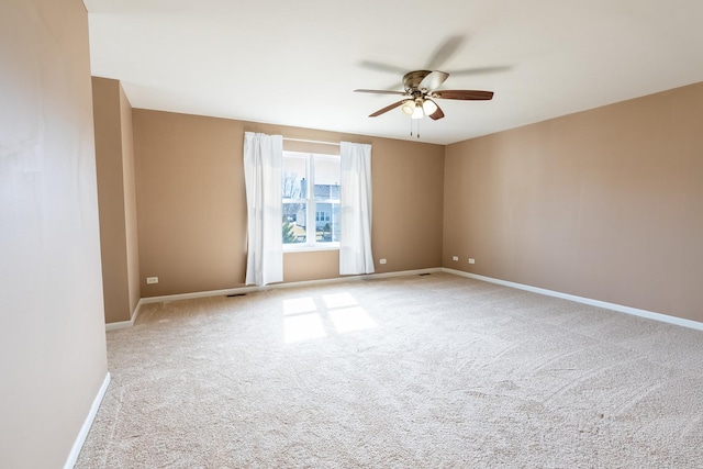 unfurnished room featuring carpet, baseboards, and ceiling fan