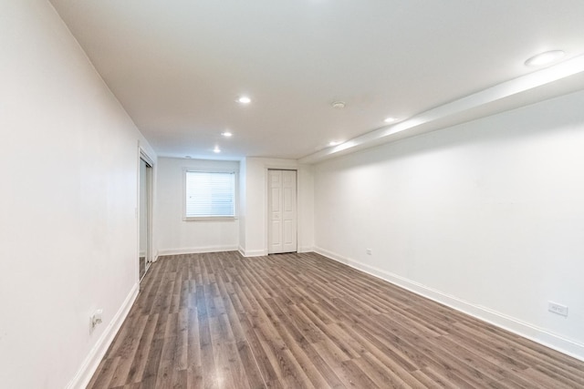 basement featuring baseboards, recessed lighting, and wood finished floors