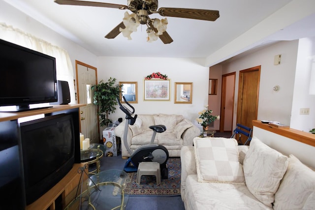 living room with carpet and a ceiling fan
