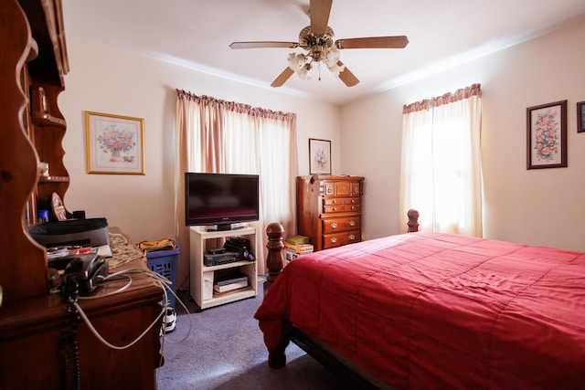 carpeted bedroom with multiple windows and a ceiling fan