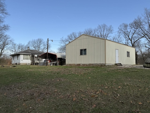 view of pole building featuring a detached carport and a lawn