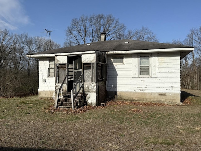 rear view of house featuring a chimney