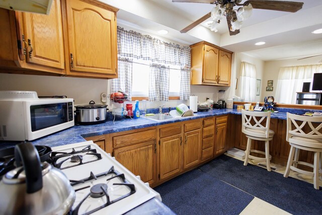 kitchen featuring ceiling fan, dark countertops, white appliances, and recessed lighting