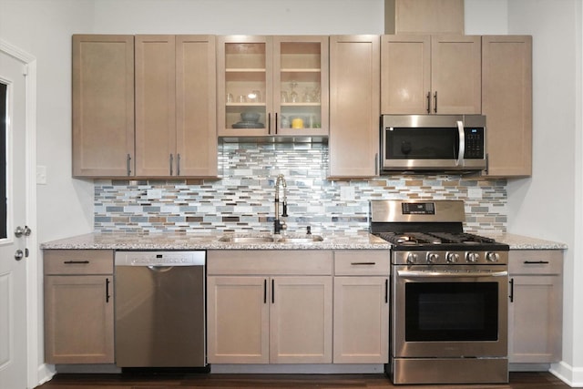 2708 Oxford Dr, Markham, IL 60426 - kitchen featuring light stone counters, backsplash, a sink, glass insert cabinets, and appliances with stainless steel finishes
