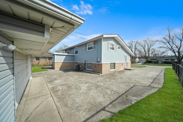 2708 Oxford Dr, Markham, IL 60426 - view of side of property with a patio area, a lawn, central AC unit, and fence