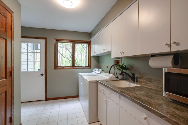 16737 W Cherrywood Ln, Wadsworth, IL 60083 - washroom with a sink, baseboards, cabinet space, and separate washer and dryer