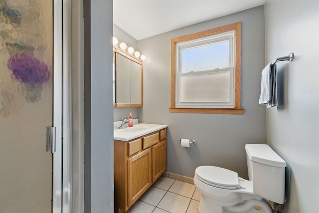 bathroom featuring baseboards, toilet, vanity, and tile patterned floors