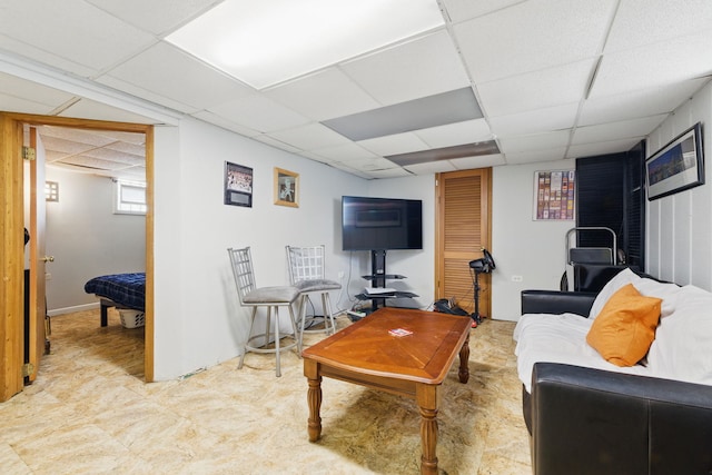 living room with a drop ceiling