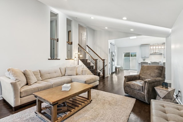 living room with recessed lighting, dark wood-style floors, stairs, lofted ceiling, and baseboards