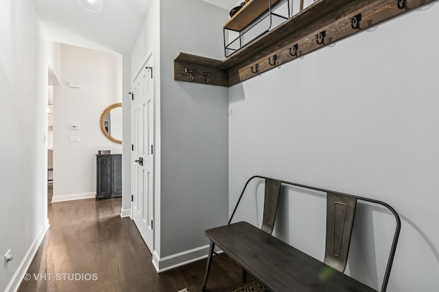 mudroom with dark wood finished floors and baseboards