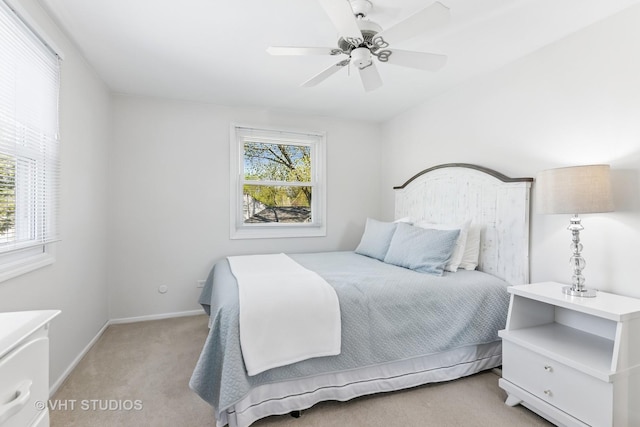 bedroom with light carpet, baseboards, and a ceiling fan