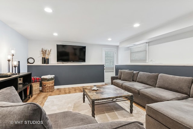 living room with light wood-style floors and recessed lighting