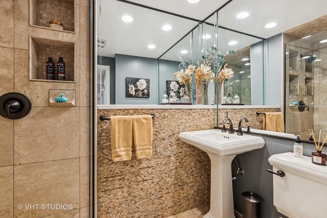 bathroom featuring a shower stall, toilet, and recessed lighting